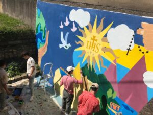 students painting mural