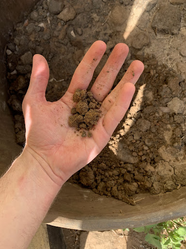 outstretched palm with clay for stove pot production