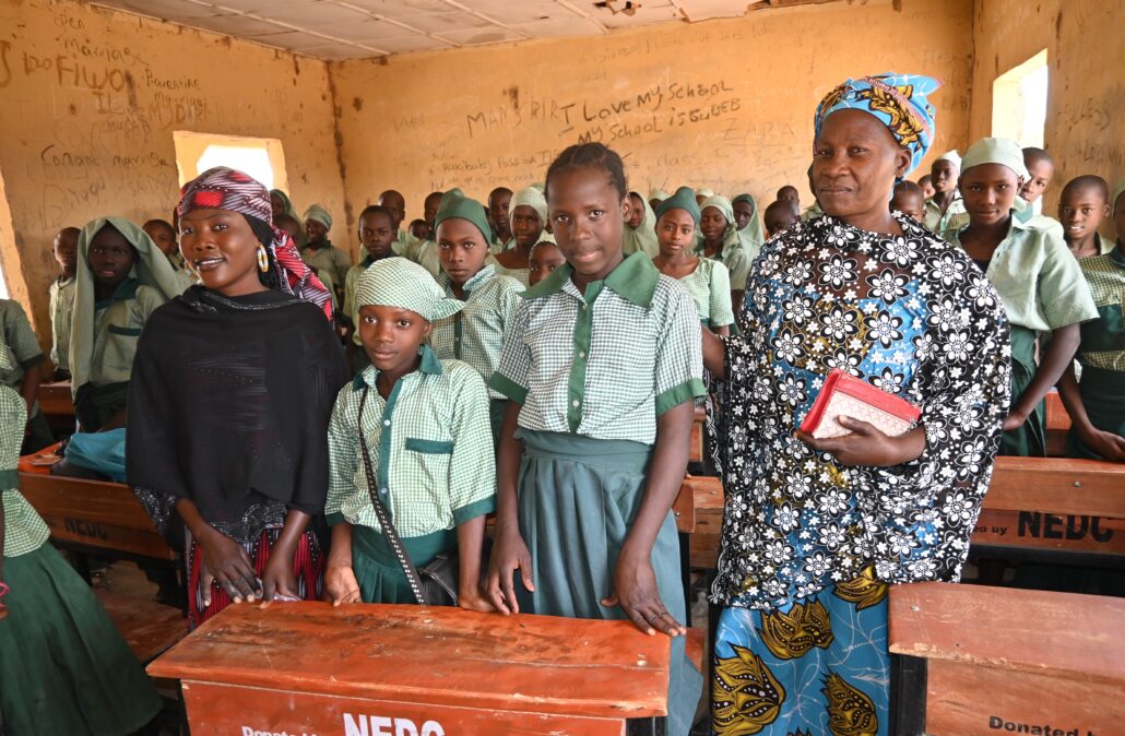 Teachers in classroom with students at girl's school club