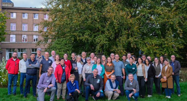 Group photo outside - regional coordination group meeting pose for photo.