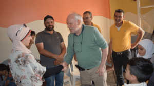 John meets project families and shakes their hands