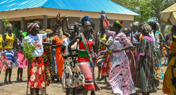 villager dance in celebration of new school building
