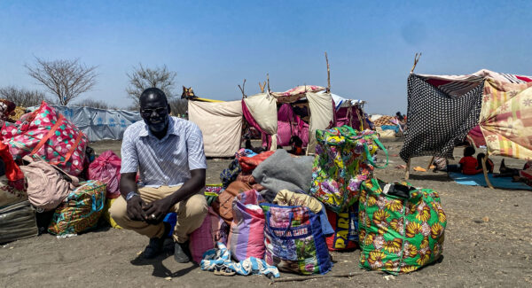 refugee community leader picture outside refugee camp