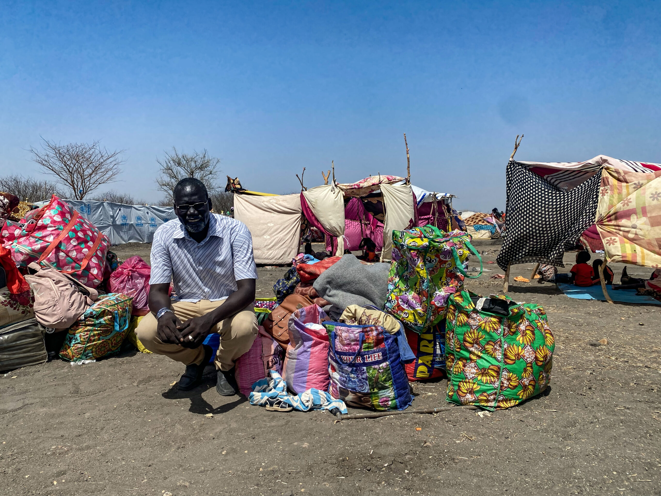 refugee community leader picture outside refugee camp