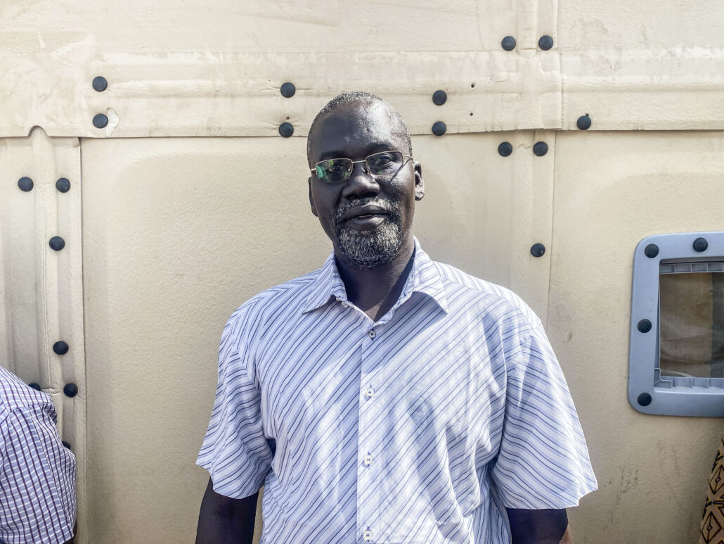 Refugee poses for camera. He is a community leader at the refugee camp. 