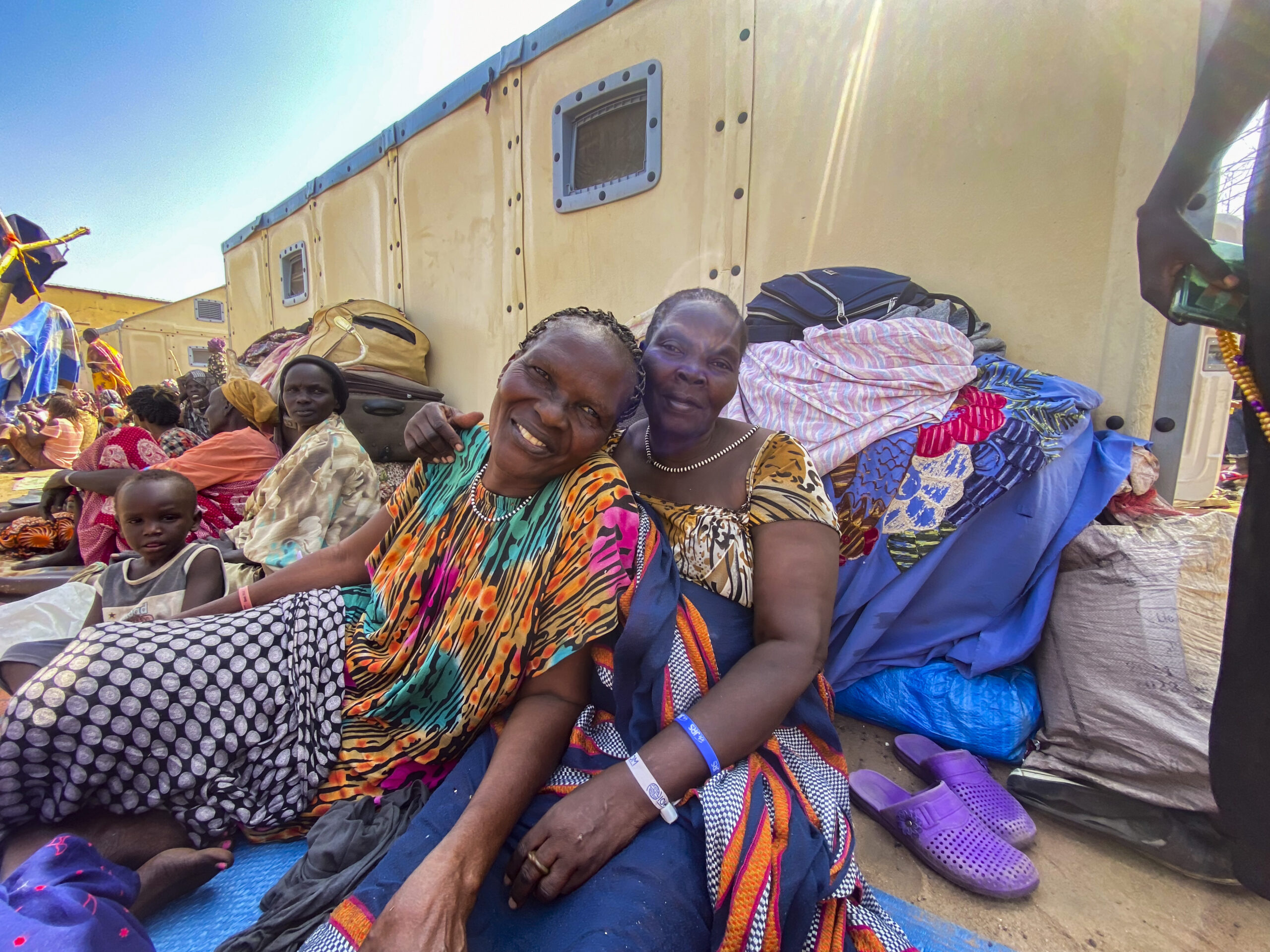 Catherine and Santuki pose for photo outside aid distribution station.