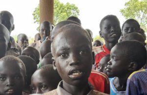 School children a pictured sweating in the shade from extreme heat in South Sudan.