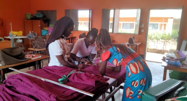 women tailoring and cutting material to measure for pads.