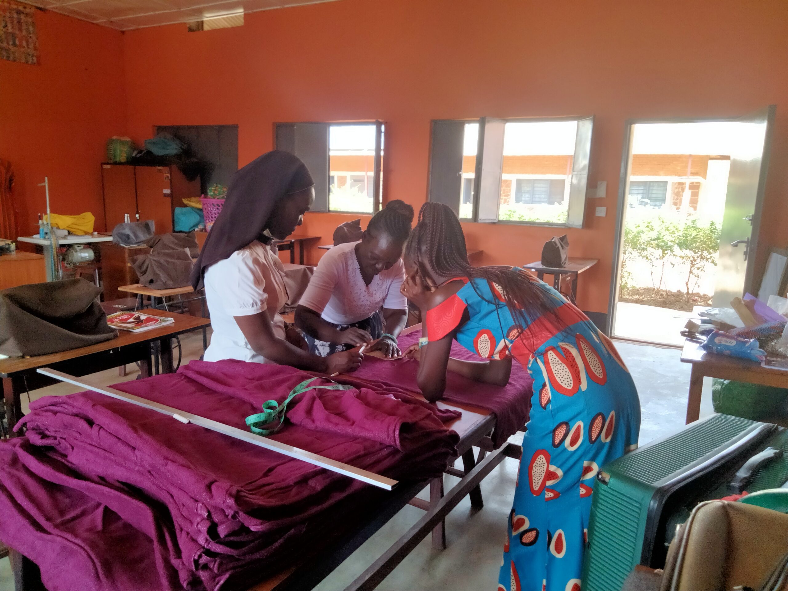 women tailoring and cutting material to measure for pads.