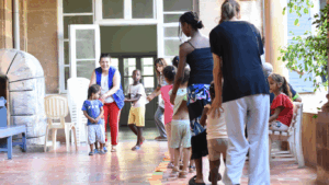 photo shows children playing in the Arrupe migrant centre used to shelter refugees.