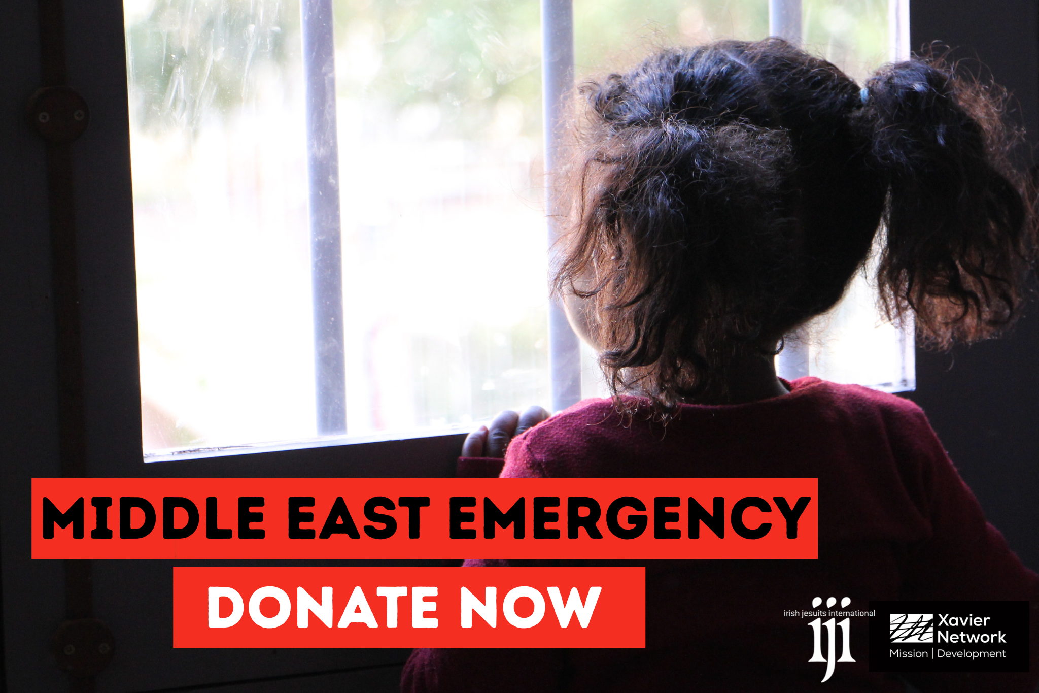Girl in Lebanon looks out from the window at an emergency shelter