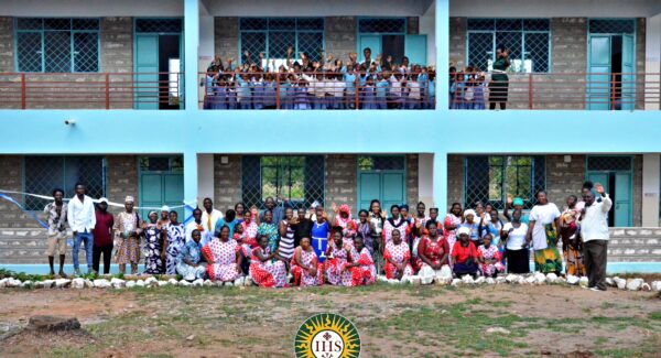 Malindi school opening. community pose for photo outside the school building